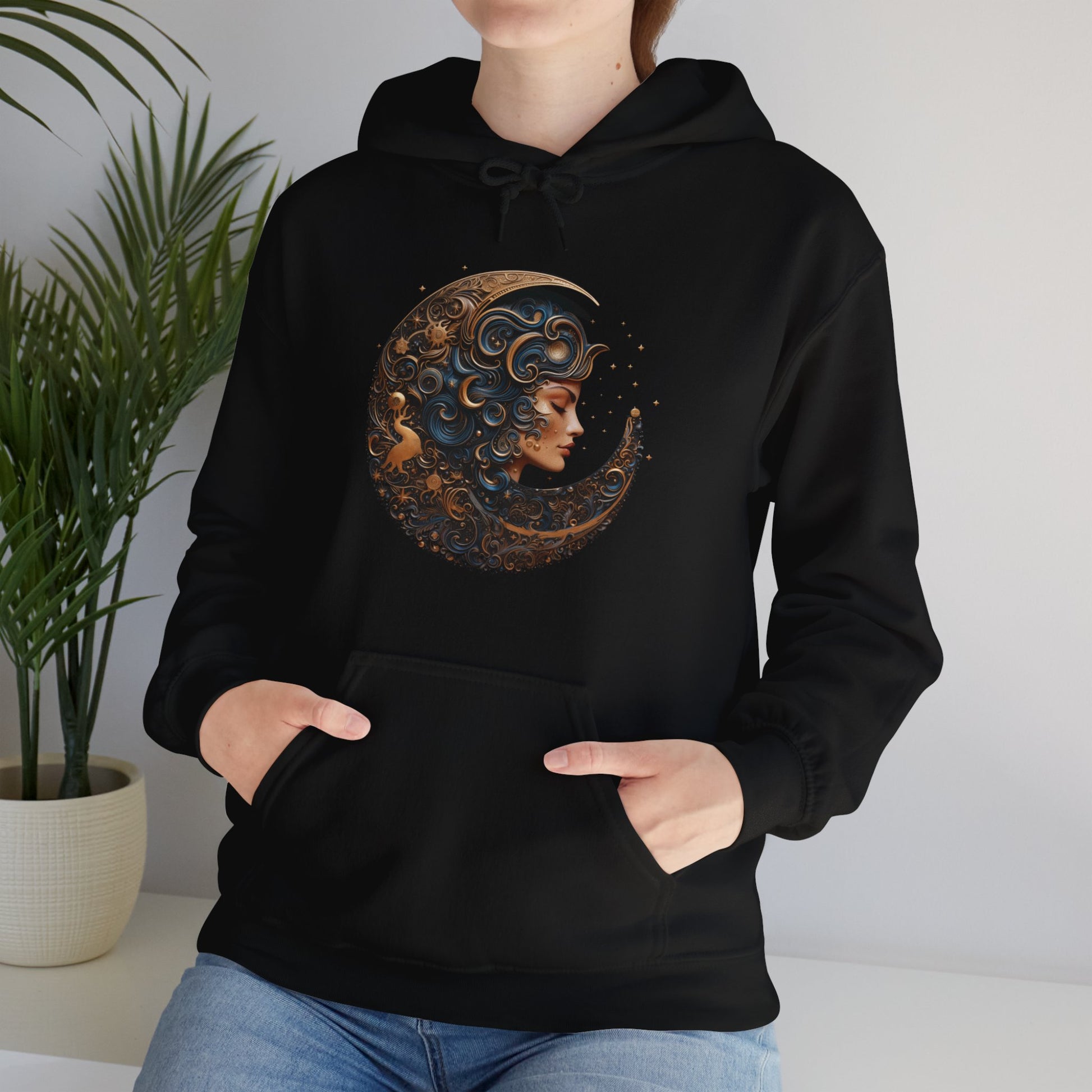 Goddess of the Night Sky sweatshirt. Woman wearing a black hoodie with the image of a a crescent moon surrounding a woman's face