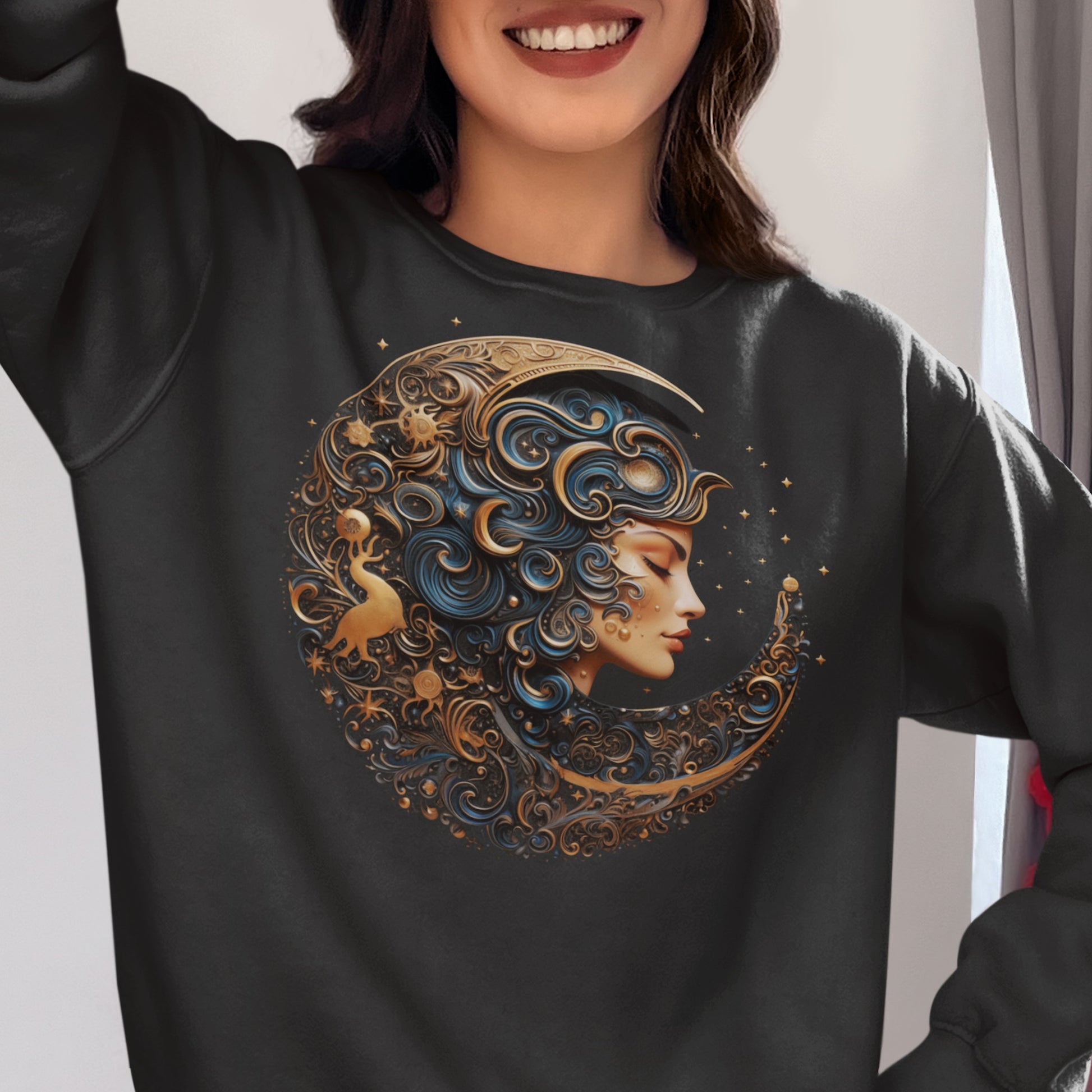 Goddess of the Night Sky sweatshirt. Woman wearing a black sweatshirt with the image of a a crescent moon surrounding a woman's face